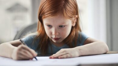 girl writing on paper