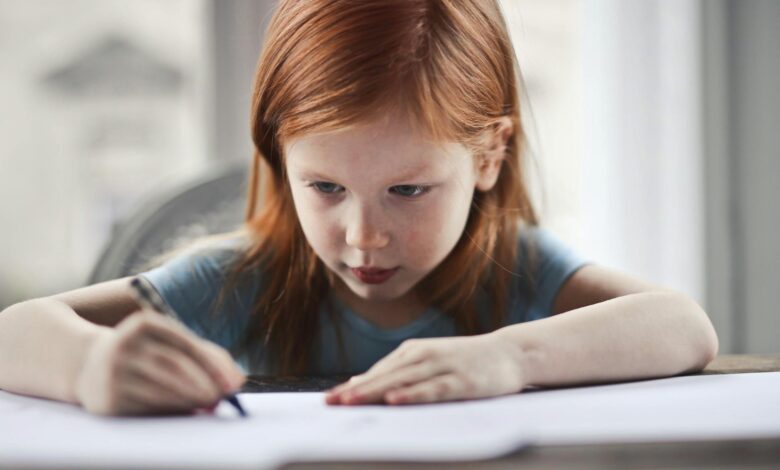 girl writing on paper