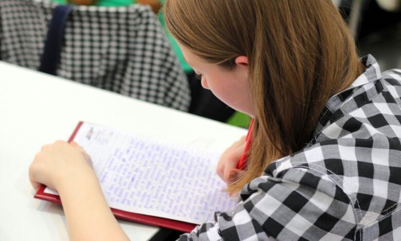 woman writing on paper