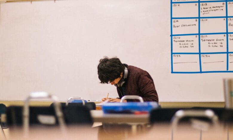 man writing on table