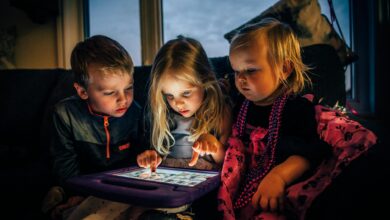 three children looking at a tablet computer