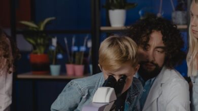 student looking at a microscope