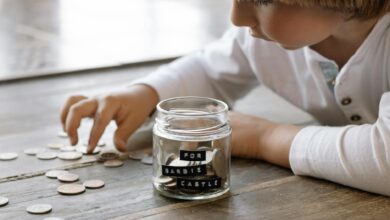 little child playing with coins on floor