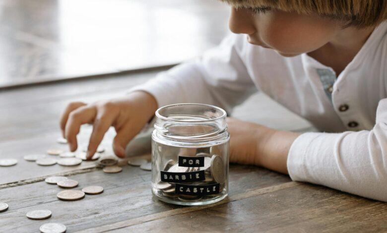 little child playing with coins on floor