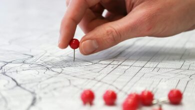 hand placing pin on map
