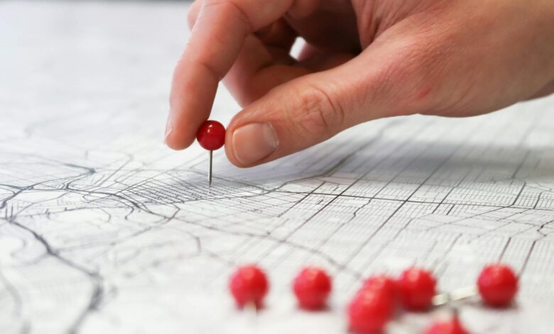 hand placing pin on map