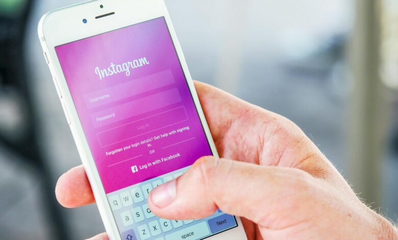 person holding phone while logging in on instagram application