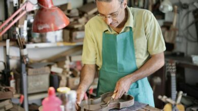 senior artisan working with wooden details in workshop