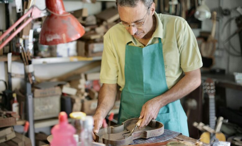 senior artisan working with wooden details in workshop
