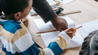smart kids studying with teacher in classroom