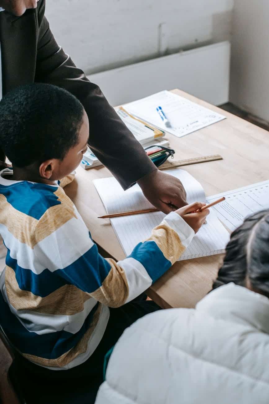 smart kids studying with teacher in classroom
