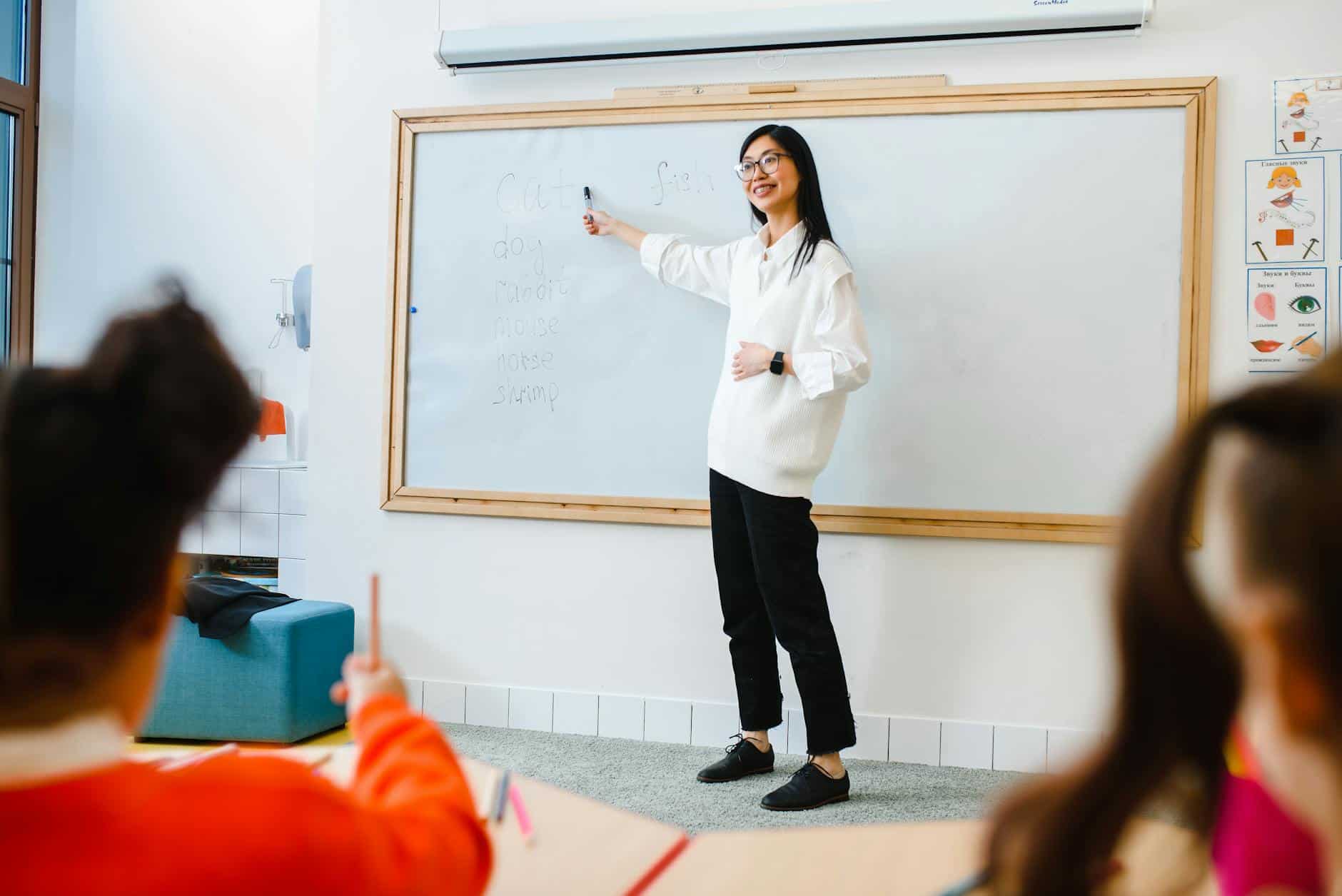 a woman teaching in front of the class