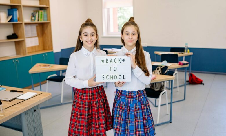 twins holding a letter board