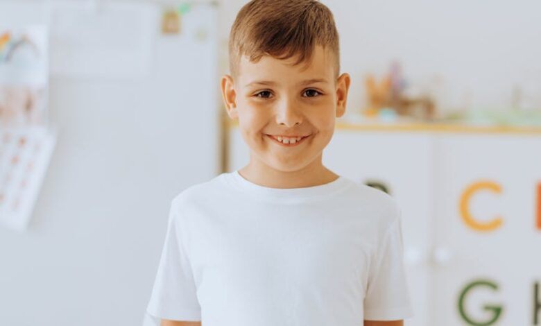 boy in white crew neck shirt holding a book