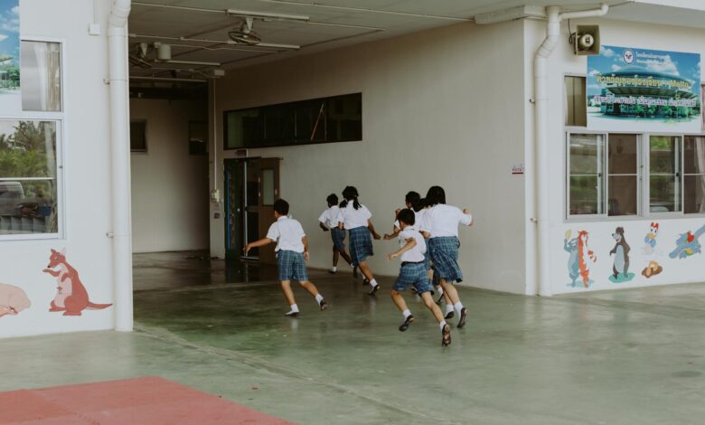 a group of students running inside the school