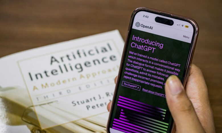 close up of a person holding a smartphone displaying chatgpt