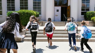 back view shot of students running to their classroom