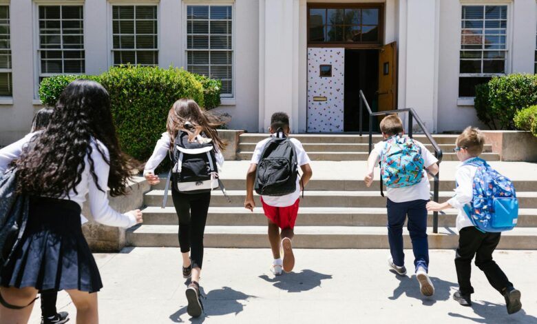 back view shot of students running to their classroom