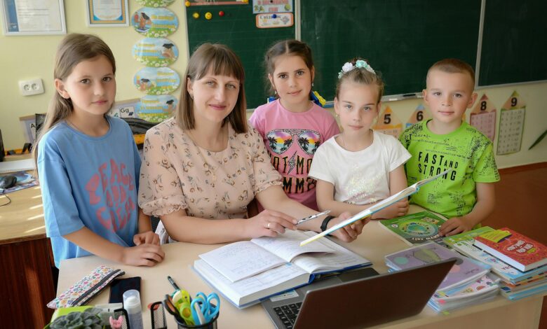 teacher and students in a classroom setting