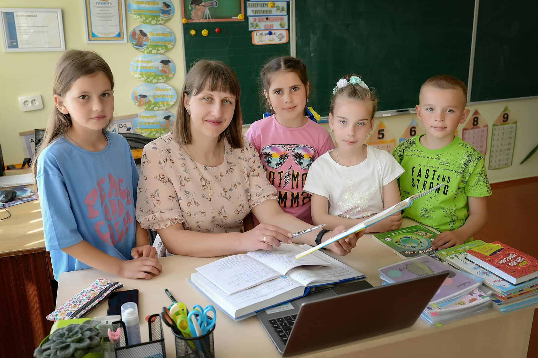 teacher and students in a classroom setting