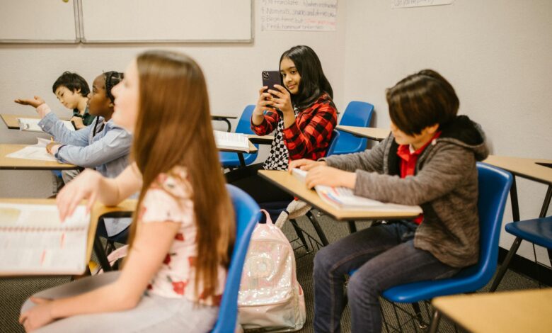girl taking photo of her classmate