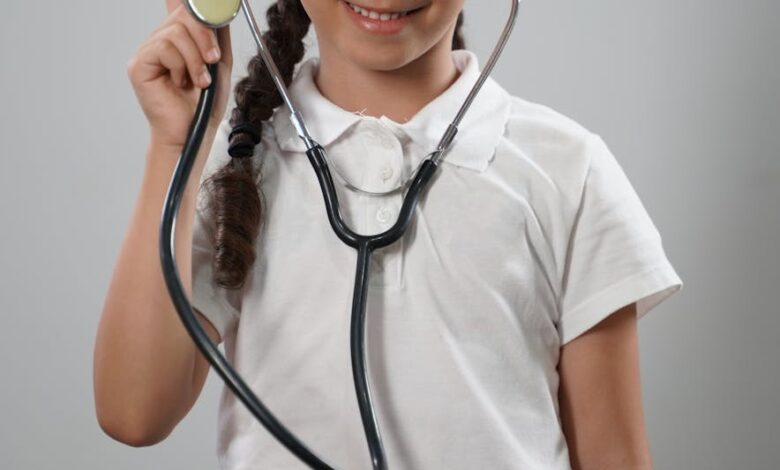 girl in white polo shirt wearing a stethoscope playing doctor