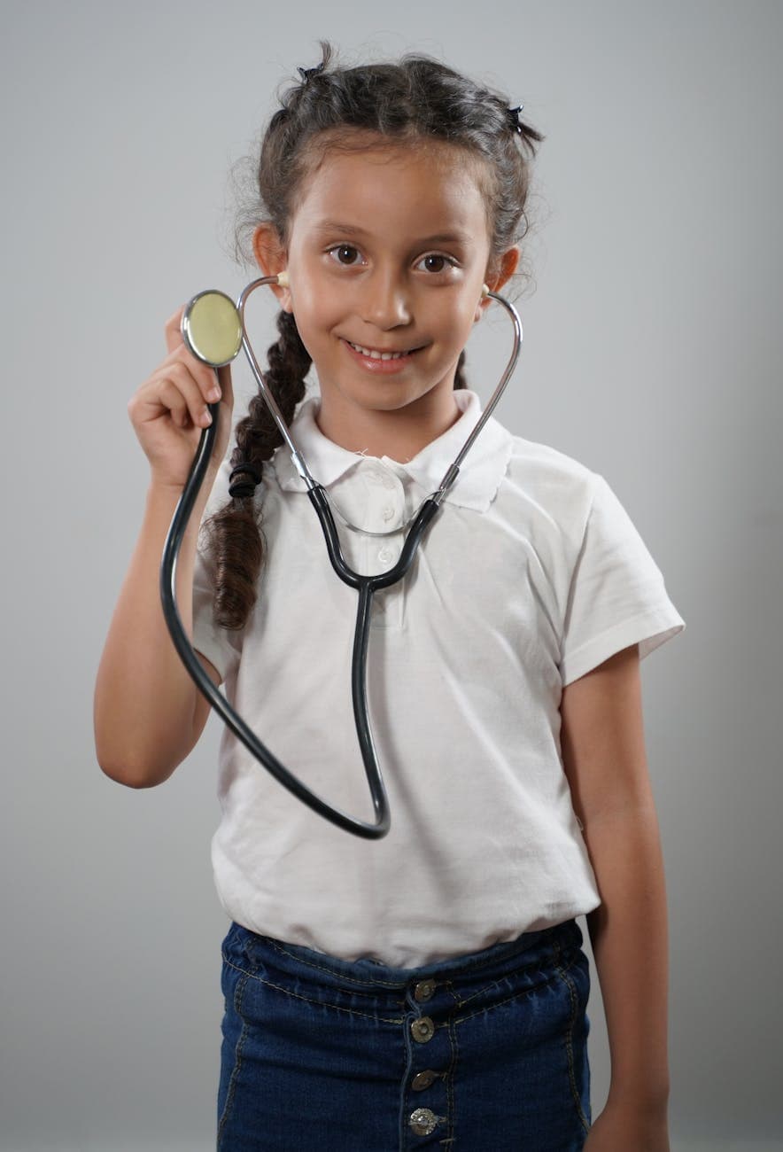 girl in white polo shirt wearing a stethoscope playing doctor