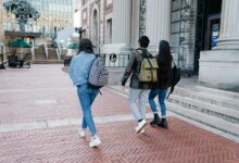 group of people walking on a sidewalk