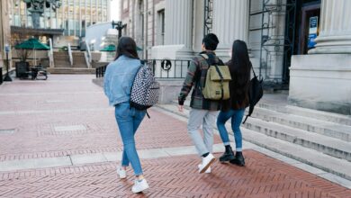 group of people walking on a sidewalk