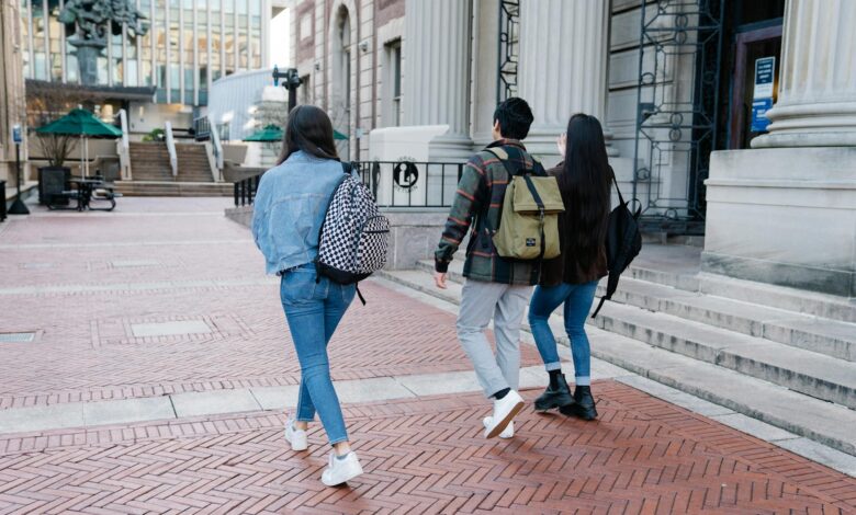 group of people walking on a sidewalk