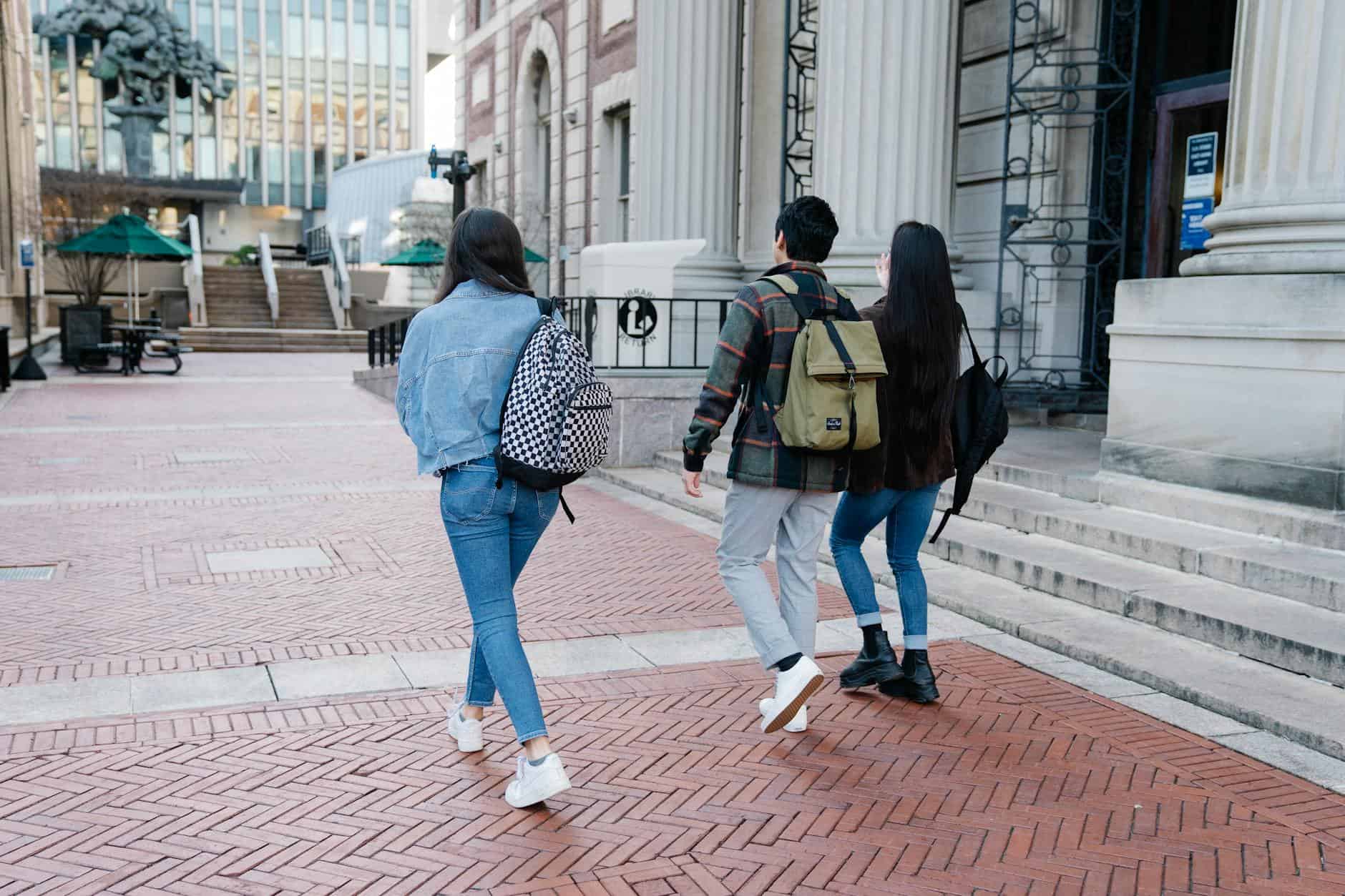 group of people walking on a sidewalk