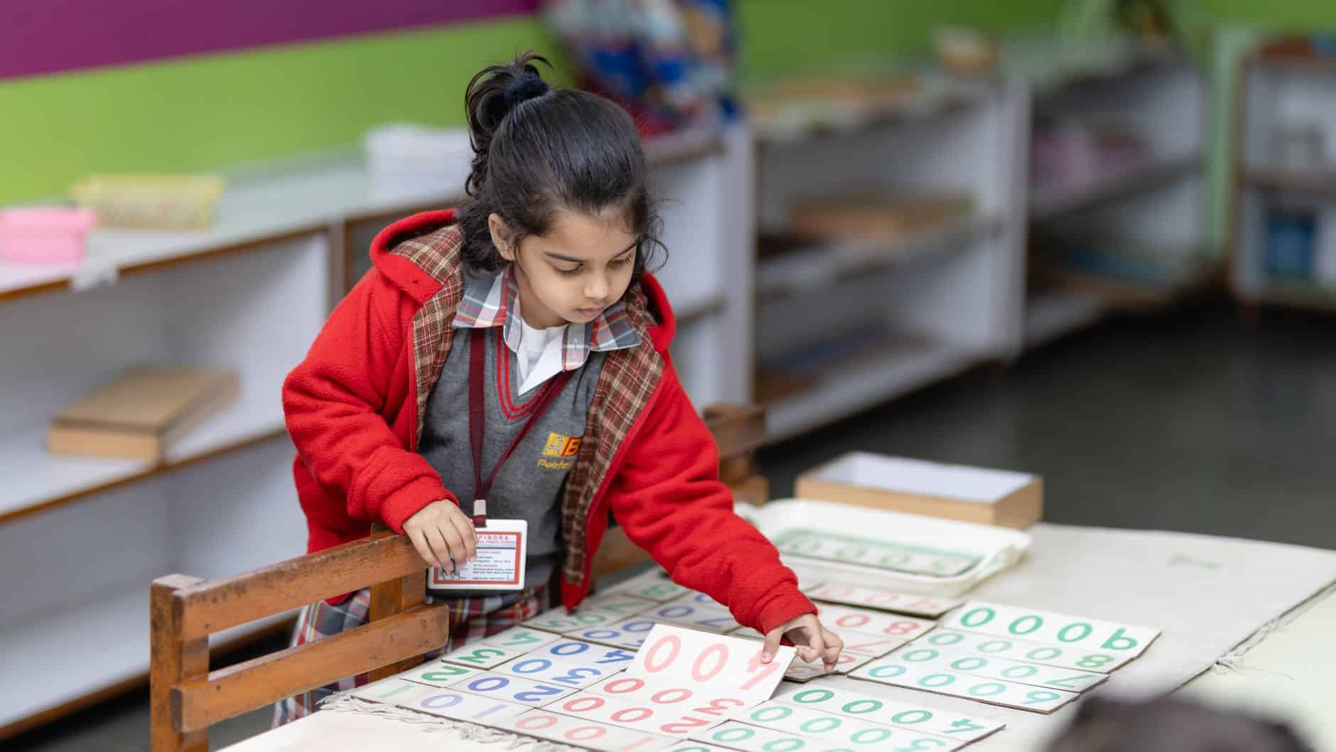 young child engaged in educational activity at school