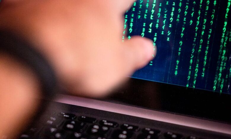 hand pointing at computer screen