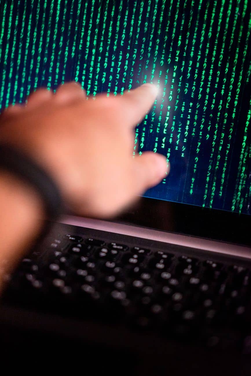 hand pointing at computer screen