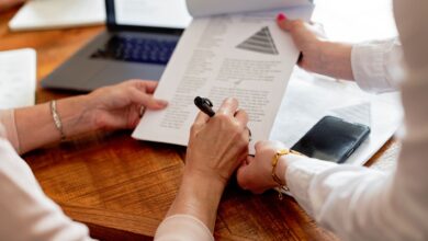 close up of women hands holding notepad