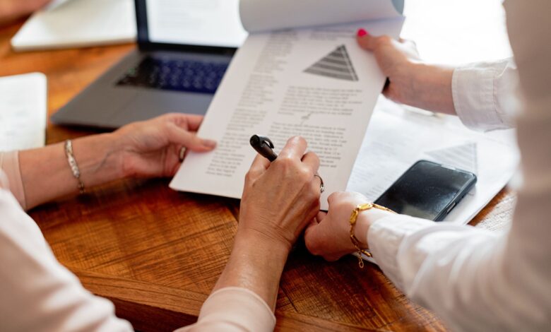 close up of women hands holding notepad