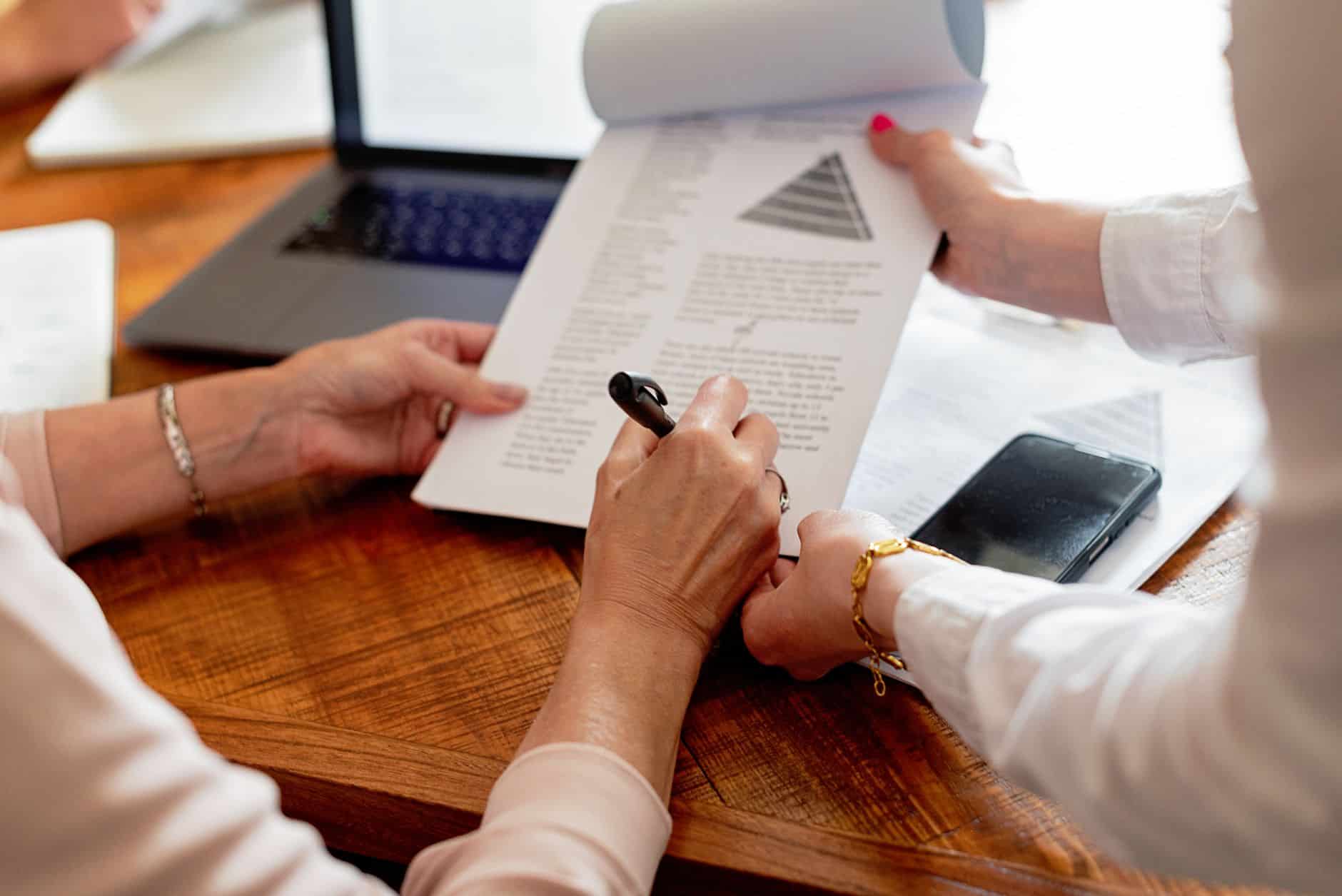 close up of women hands holding notepad