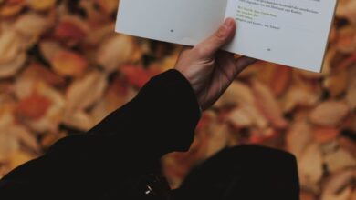 person holding white book