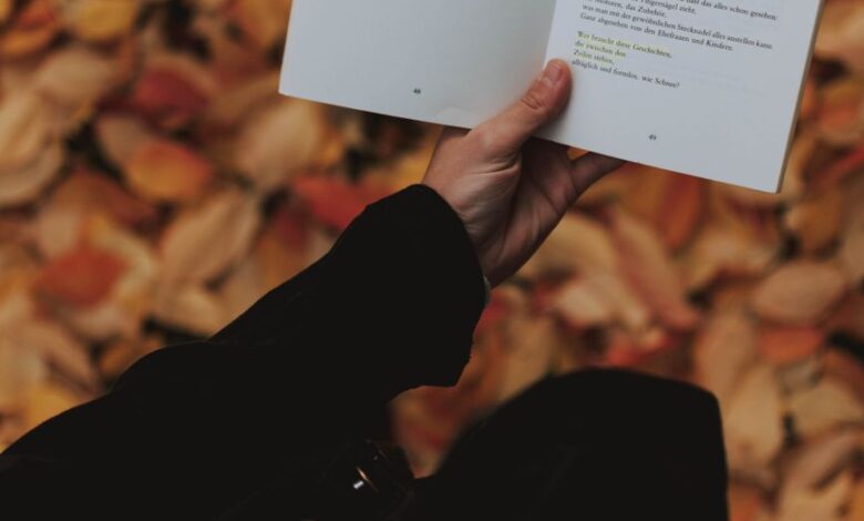 person holding white book