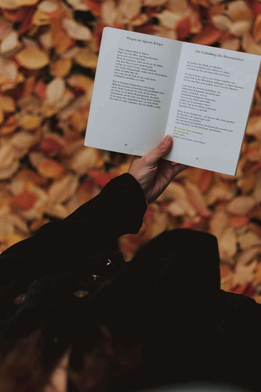person holding white book