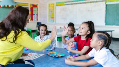 a teacher and a girl doing a high five