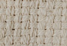 close up shot of a beige knitted textile