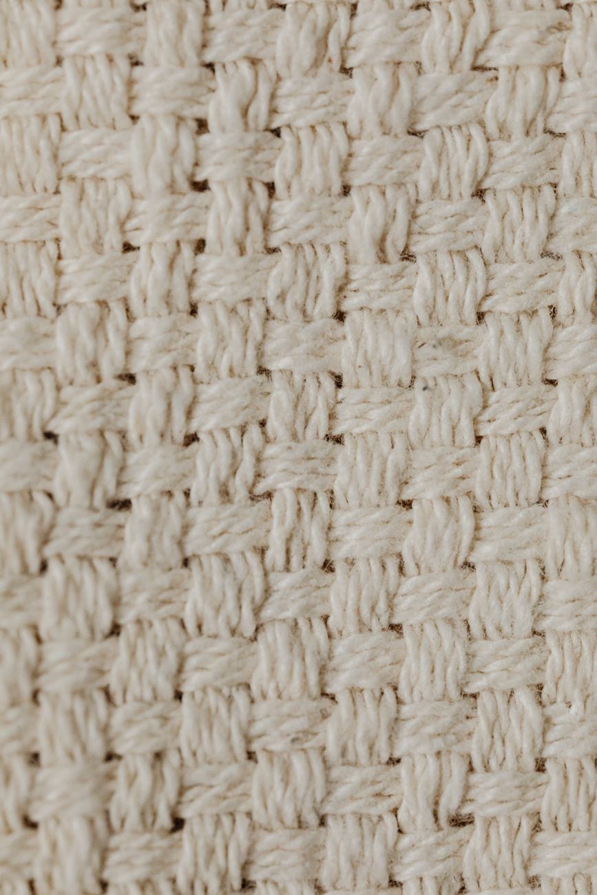 close up shot of a beige knitted textile