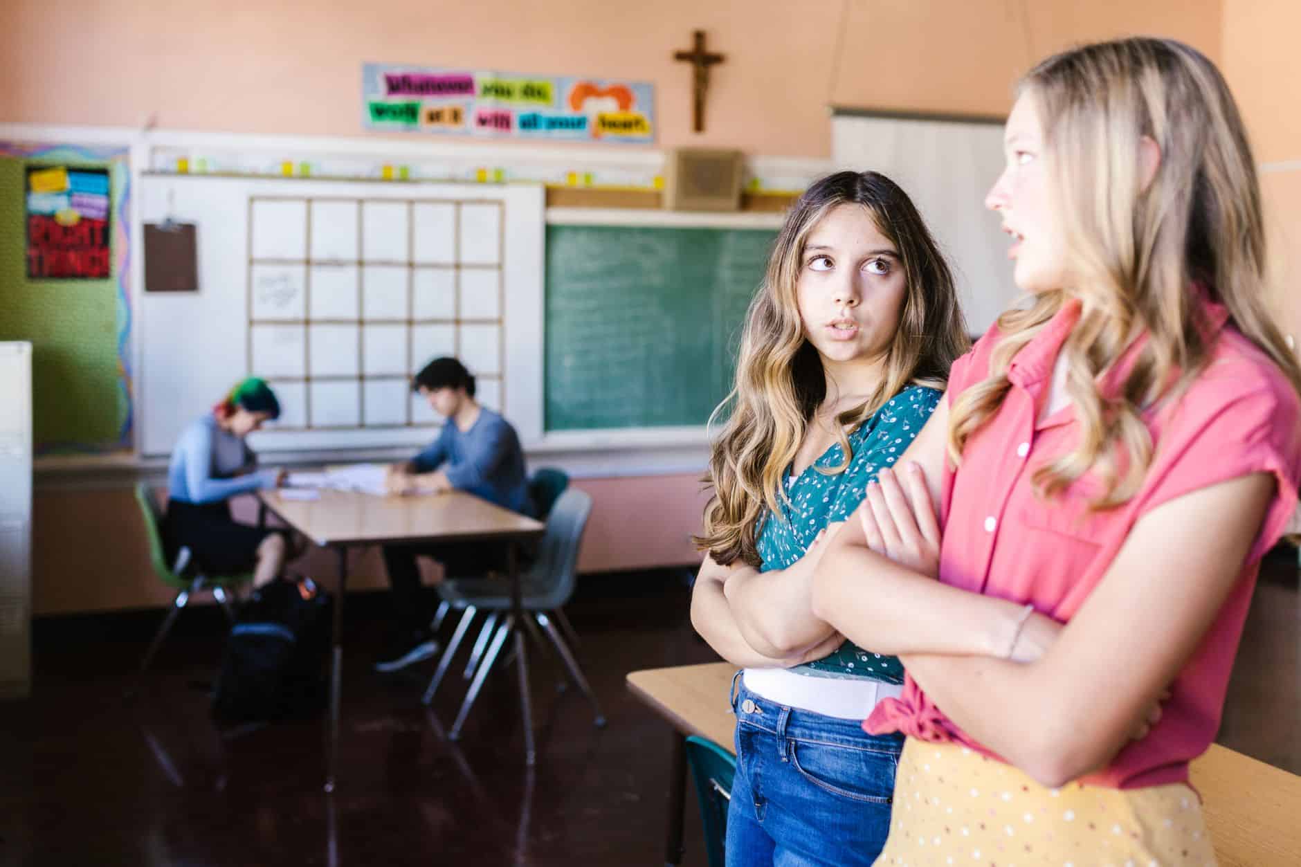 two girls talking in the classroom together