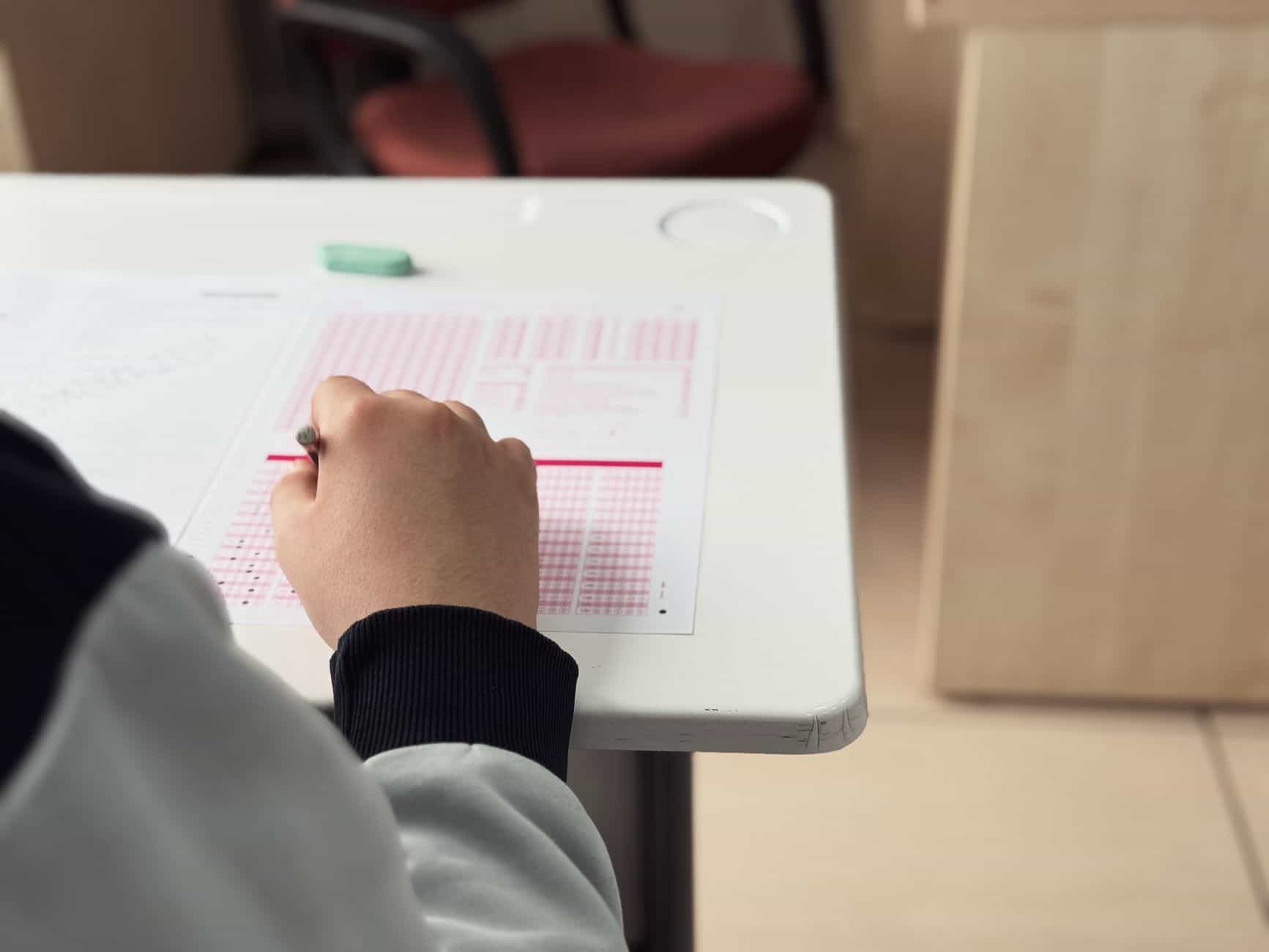 student taking exam in classroom setting