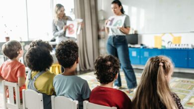 children sitting on white chairs