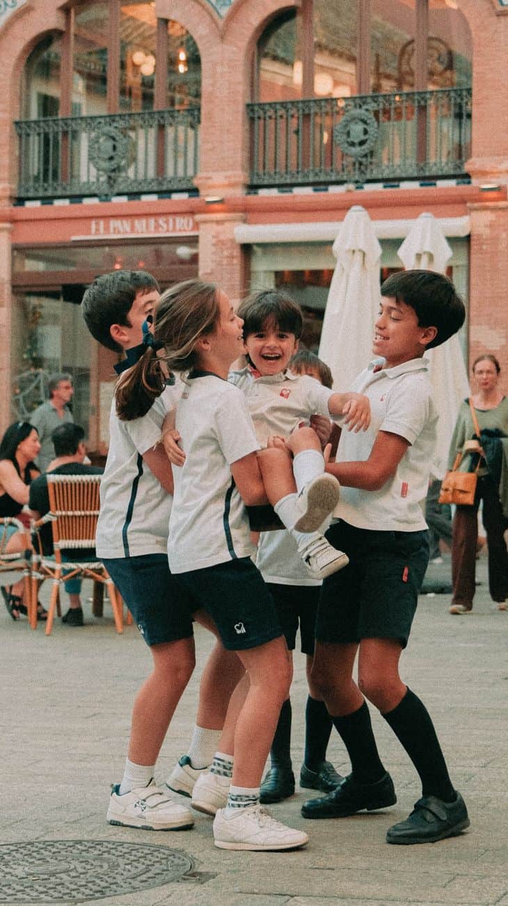 children playing joyfully in seville plaza