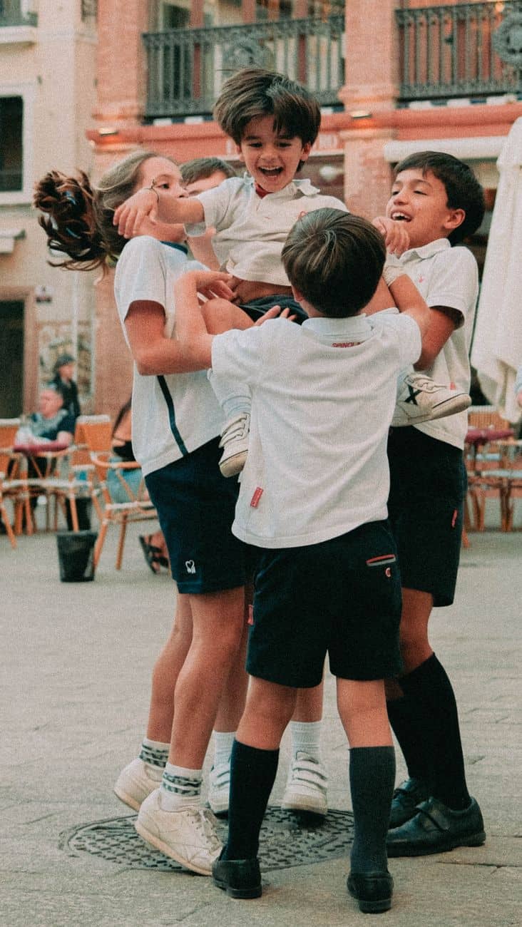 children playing joyfully in seville plaza